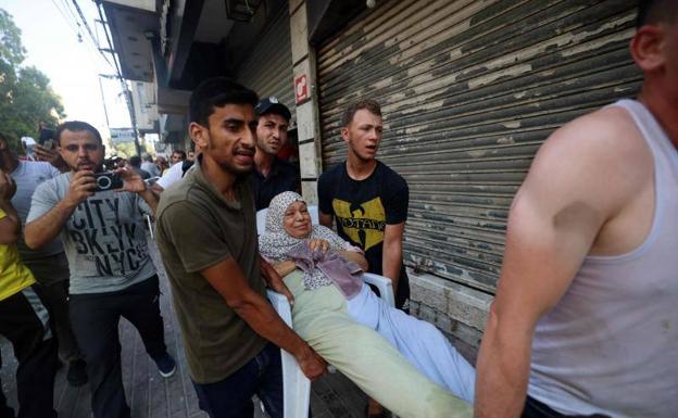 Una donna palestinese ferita è stata trasferita venerdì dopo un bombardamento israeliano nella Striscia di Gaza / Mohammed ABED / AFP