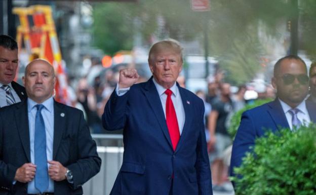 L'ex presidente Donald Trump alza il pugno in segno di vittoria mentre lascia il suo edificio per andare all'ufficio del procuratore distrettuale di New York/Reuters